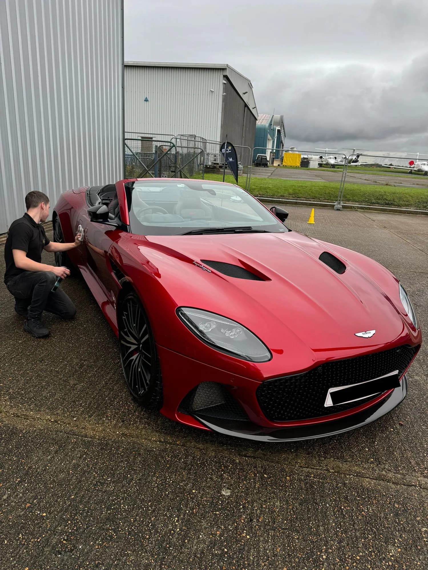 Red Aston Martin DBS being hand cleaned by Xperior Detailing