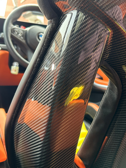 Glossy carbon fibre bucket seat after interior PPF protection service in East Midlands