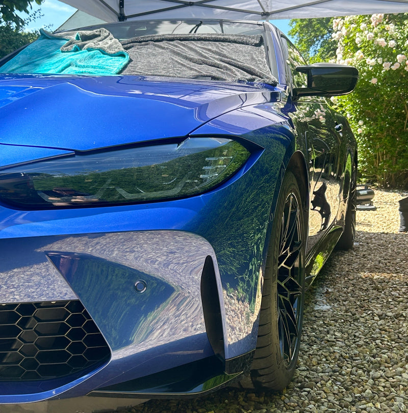Blue sports car BMW M4 glossy after exterior clean