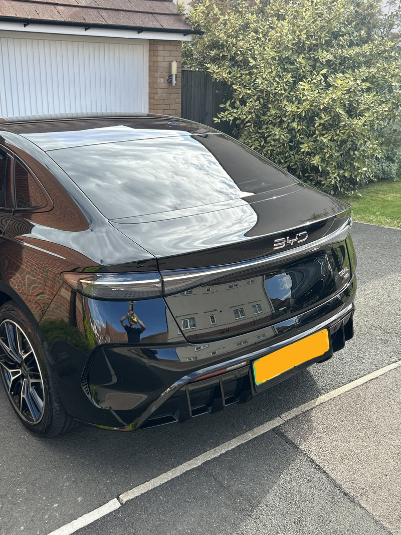 Black BYD car parked on a driveway after receiving ceramic coating detailing package