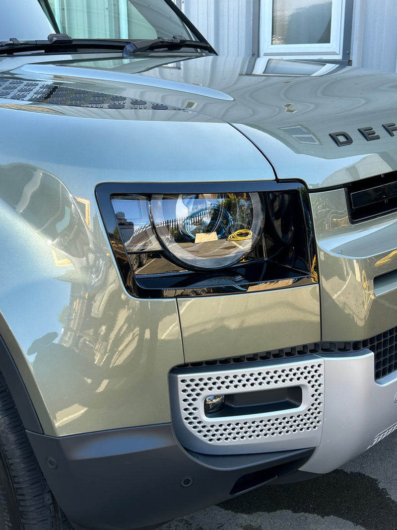 Bronze Land Rover Defender 90 front side view in sunlight, paintwork looking glossy and clean after valeting