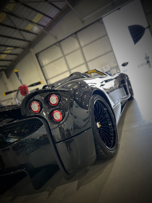 pagani huayra carbon fibre edition hypercar, back view very glossy after car detailing