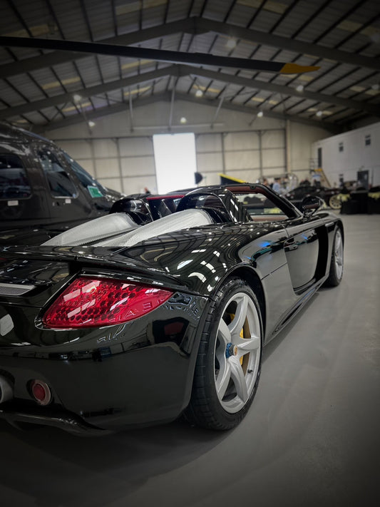 very glossy paint on porsche carrera gt, side back view of porsche carrera gt after it has been car detailed