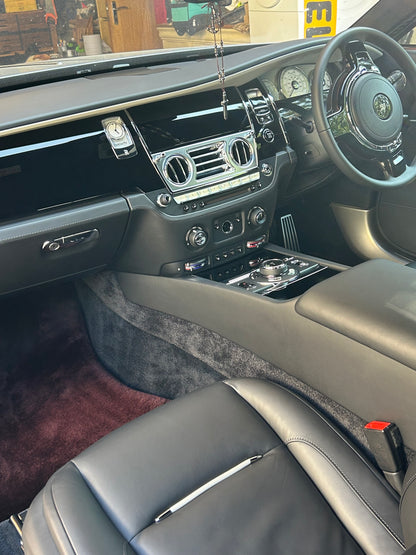detailed Rolls-Royce interior featuring clean leather seats and polished gloss black trim by Xperior Detailing in Northampton